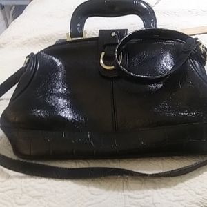 Vintage 1980 woman patent leather black with gold hard ware footed bottom satche